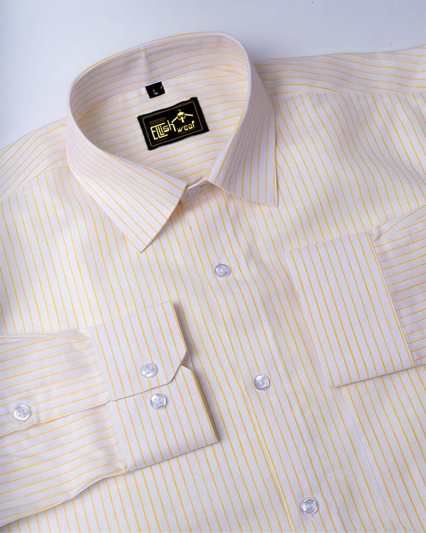 Yellow striped dress shirt with a brand label on a white background
